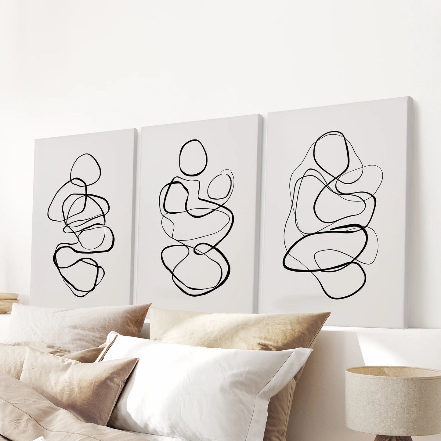 Scribble line art becomes a 3-piece canvas triptych for the bedroom, scaled to sit cleanly above the bed headboard with understated texture.