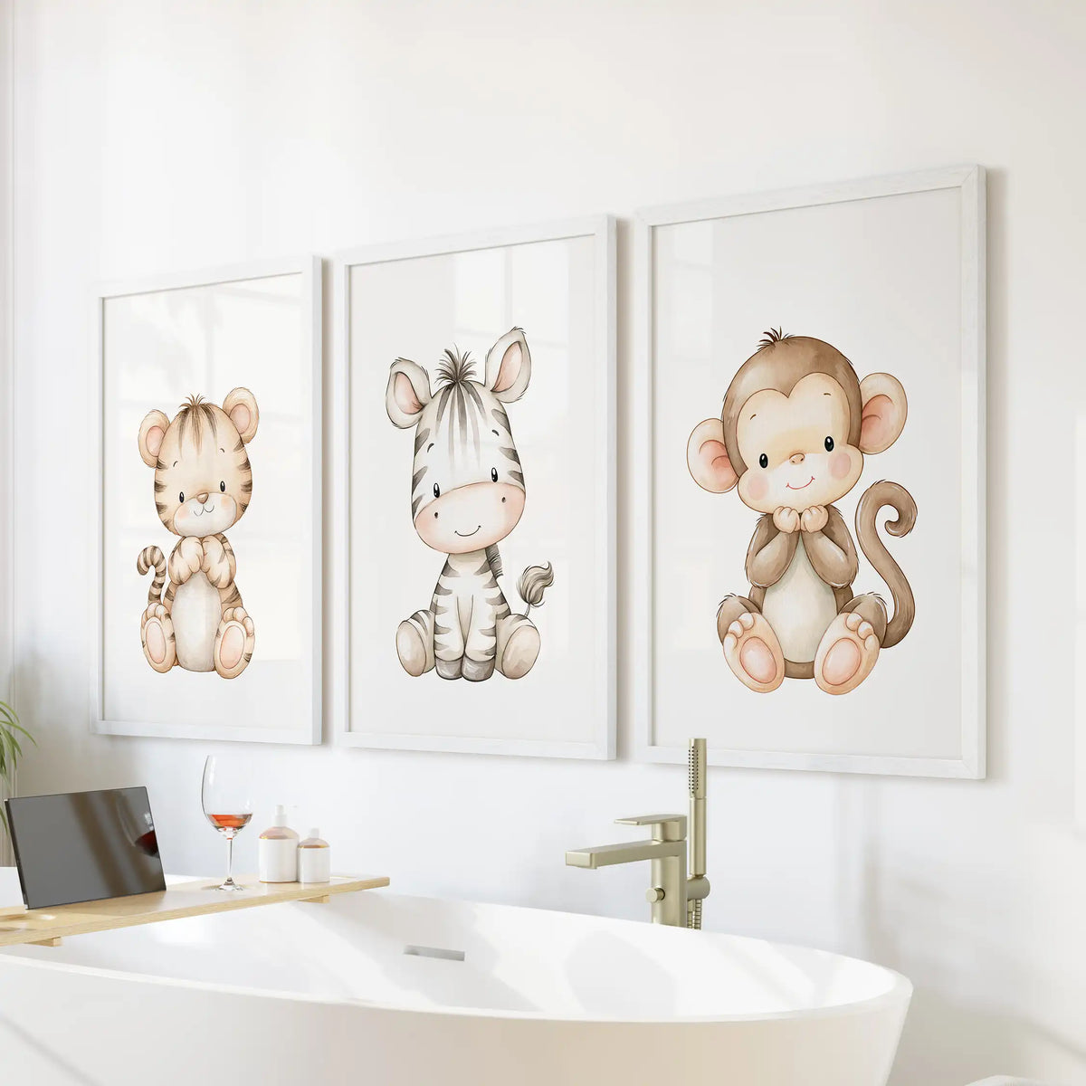 White frames surround three baby animal prints above a freestanding bathtub; the monkey at right has a curled tail.
