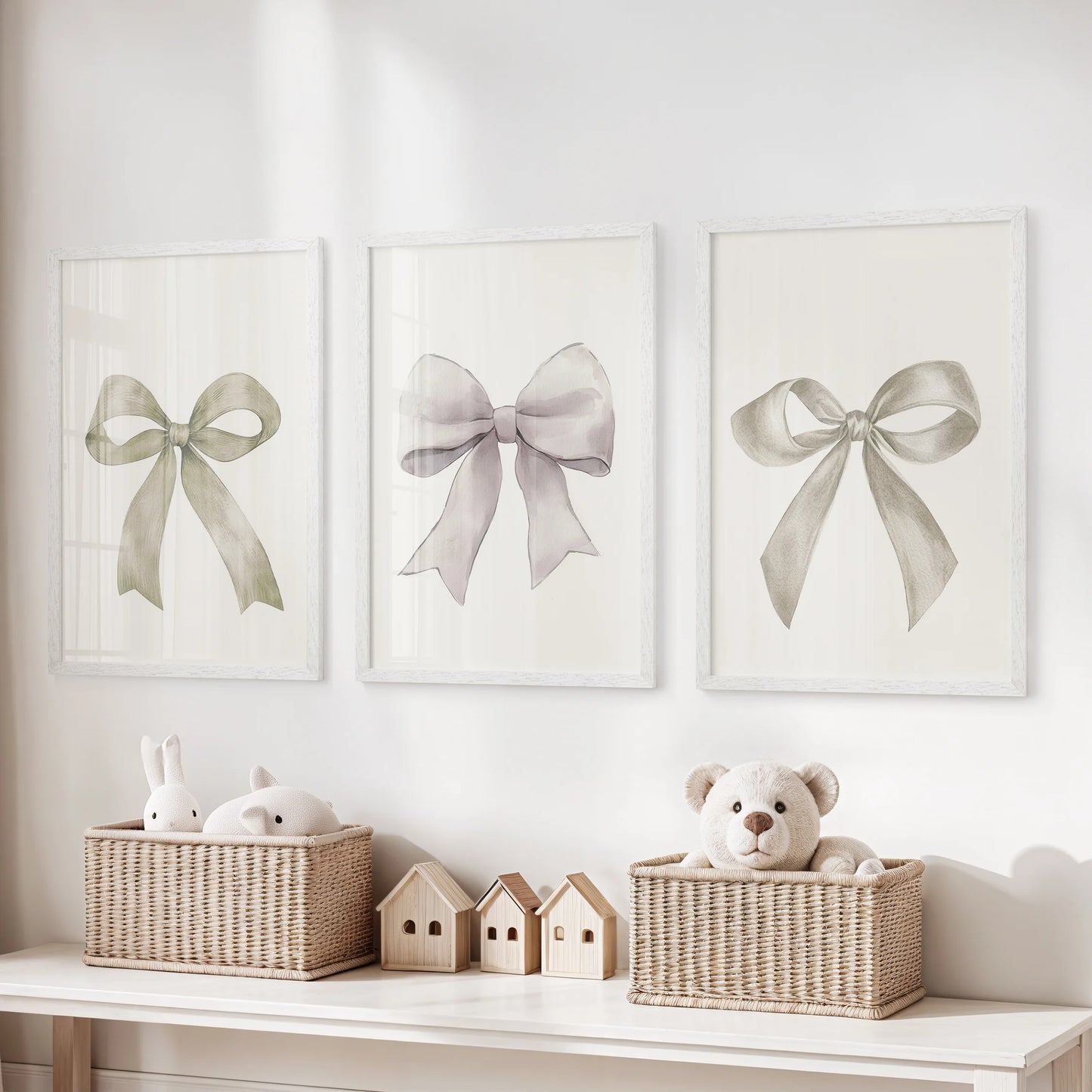 Three neutral bow artworks framed in white brighten the playroom, their calm cream tone balancing playful energy with tidy charm.