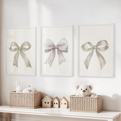 Three neutral bow artworks framed in white brighten the playroom, their calm cream tone balancing playful energy with tidy charm.
