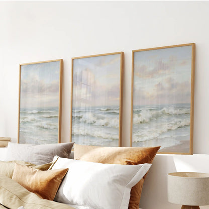 Neutral seascape horizons, a wall art three-piece set in wooden frames, make a tranquil statement above the bedroom headboard.