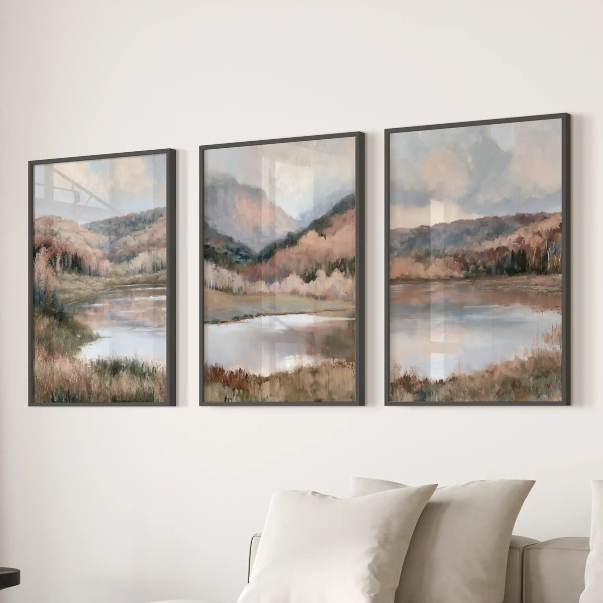 Soft autumn nature scenes, a triptych of black-framed prints, anchor the sitting room when mounted over the sectional and add a gentle, neutral landscape touch.