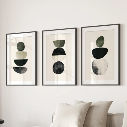 Three mid-century abstract art prints in black-matted frames line the wall behind the living-room sofa for a crisp, connected look.