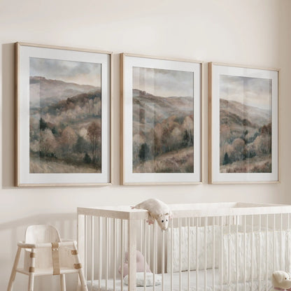 A three-piece wall hanging set of modern cottage landscapes rests over the nursery crib, warmly finished in matted solid oak frames.