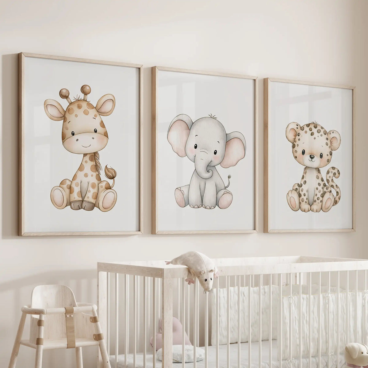 Baby safari animals appear in three oak-framed prints above a nursery crib.