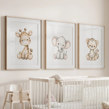 Above a white crib, oak frames with white mats hold three prints of seated baby animals: a giraffe, a gray elephant and a spotted leopard.