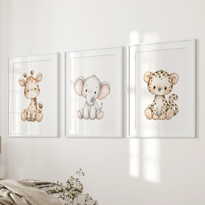 Beside a bed, three baby animal prints sit in white frames with mats.