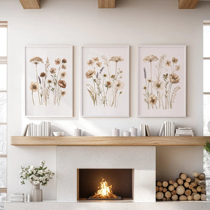 Three neutral wildflower prints in white frames above a fireplace.