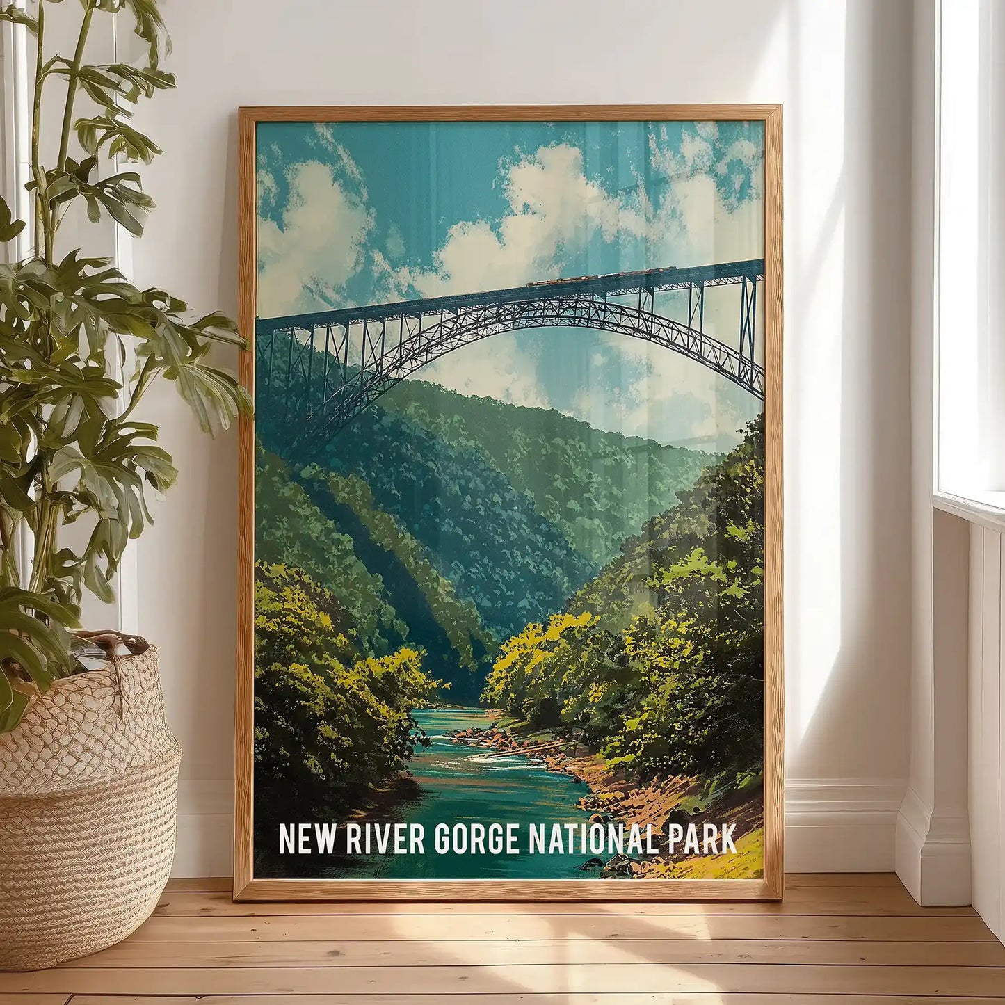 Forested canyon and soft blue sky single art piece in a light oak frame leans on a bedroom floor, lending calm, modern wall decor with an Appalachian feel.