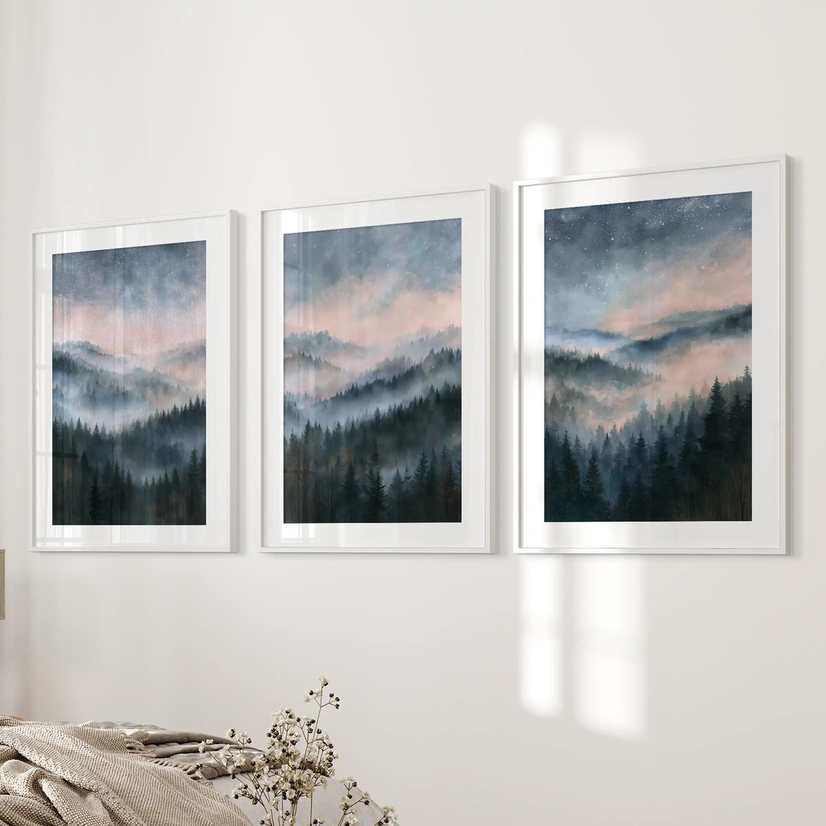 Misty mountain forest wall decor in a three-piece set, mounted in white matted frames on the bedroom wall for a soft gallery look.