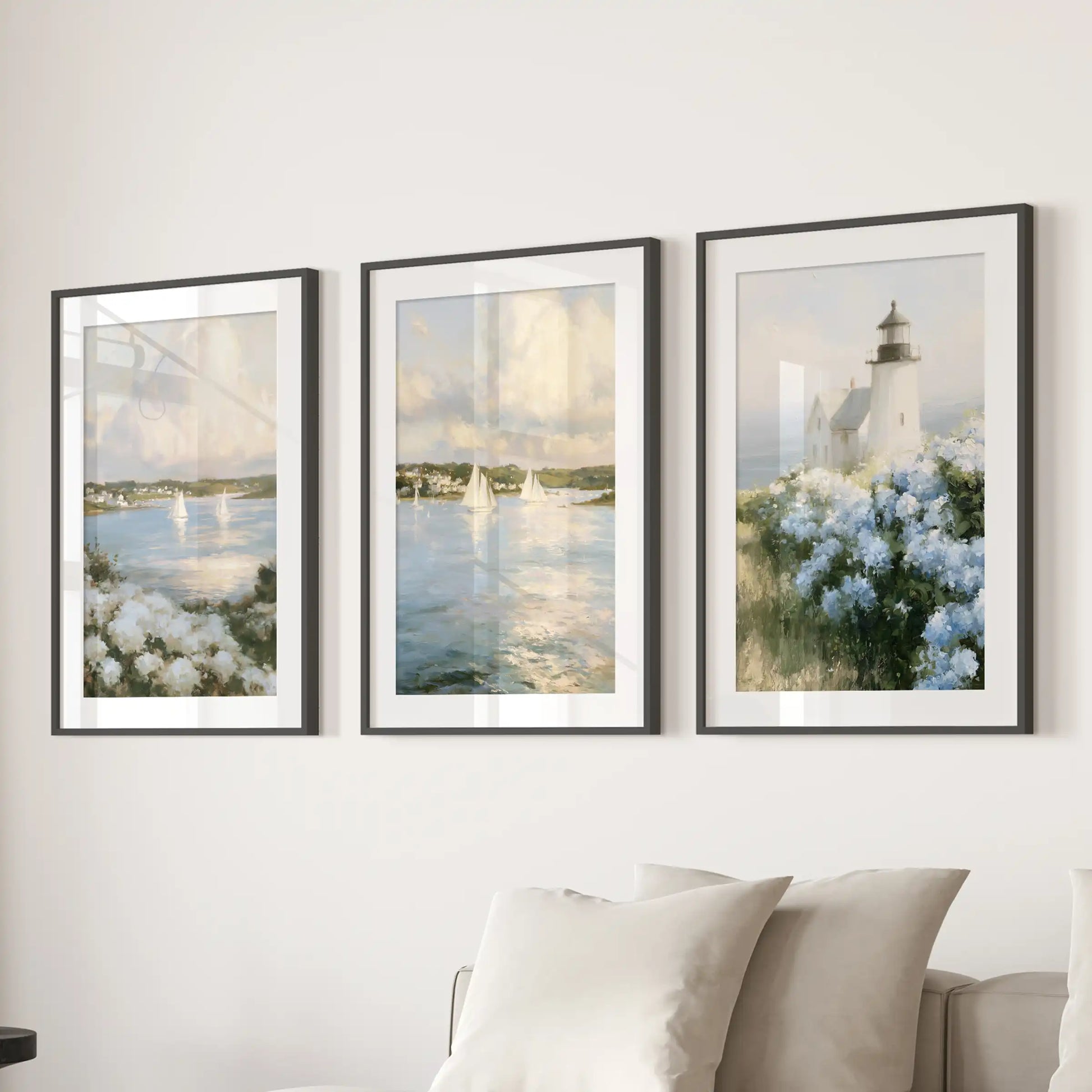 Cape Cod lighthouse 3-piece poster set, matted in black frames, anchors the family room gallery wall above the sofa with timeless coastal charm.