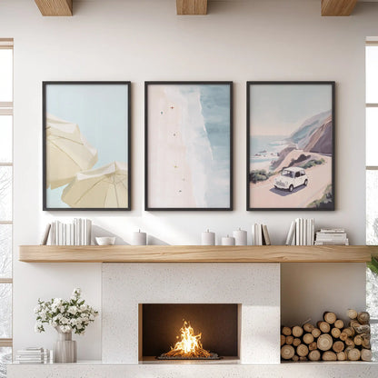 Three black-framed beach-umbrella prints form modern wall art for a family room, bringing airy coastal color above the hearth.
