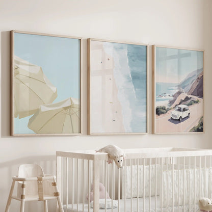 Summer beach lifestyle art, three wood-framed prints, brings lighthearted coastal energy to a baby nursery over the cot.