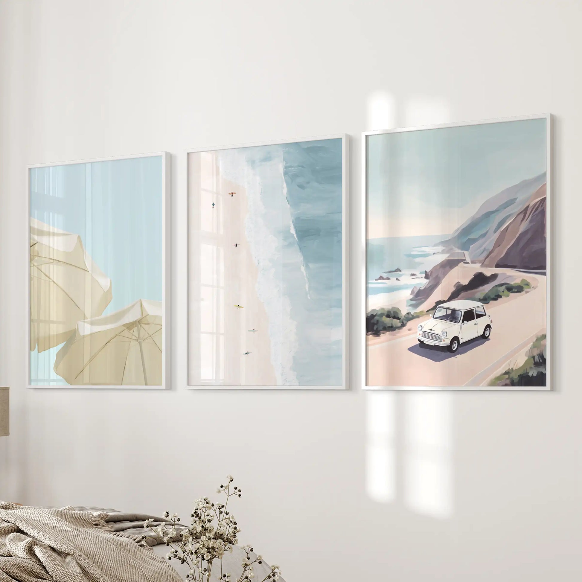 A trio of white-framed coastal road trip prints adds sunny wanderlust to the bedroom’s bedside wall.