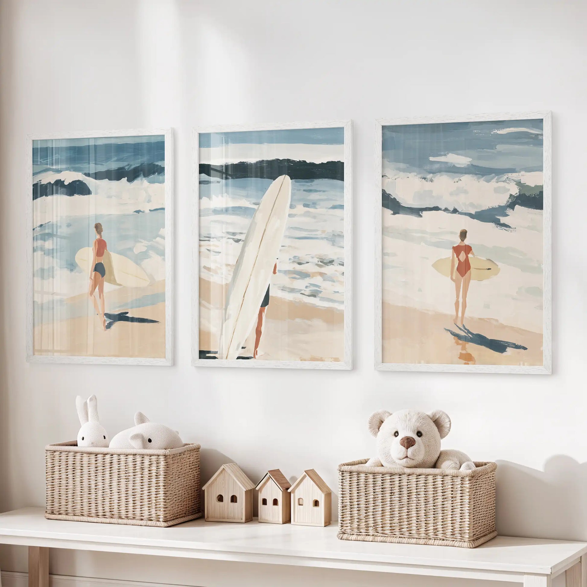 Three coastal prints in clean white frames line the playroom wall above the storage bench, adding a tidy splash of ocean blue.