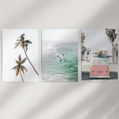 Unframed seaside wall art in three prints offers a clean, modern look across a white dining-room wall for an airy coastal touch.