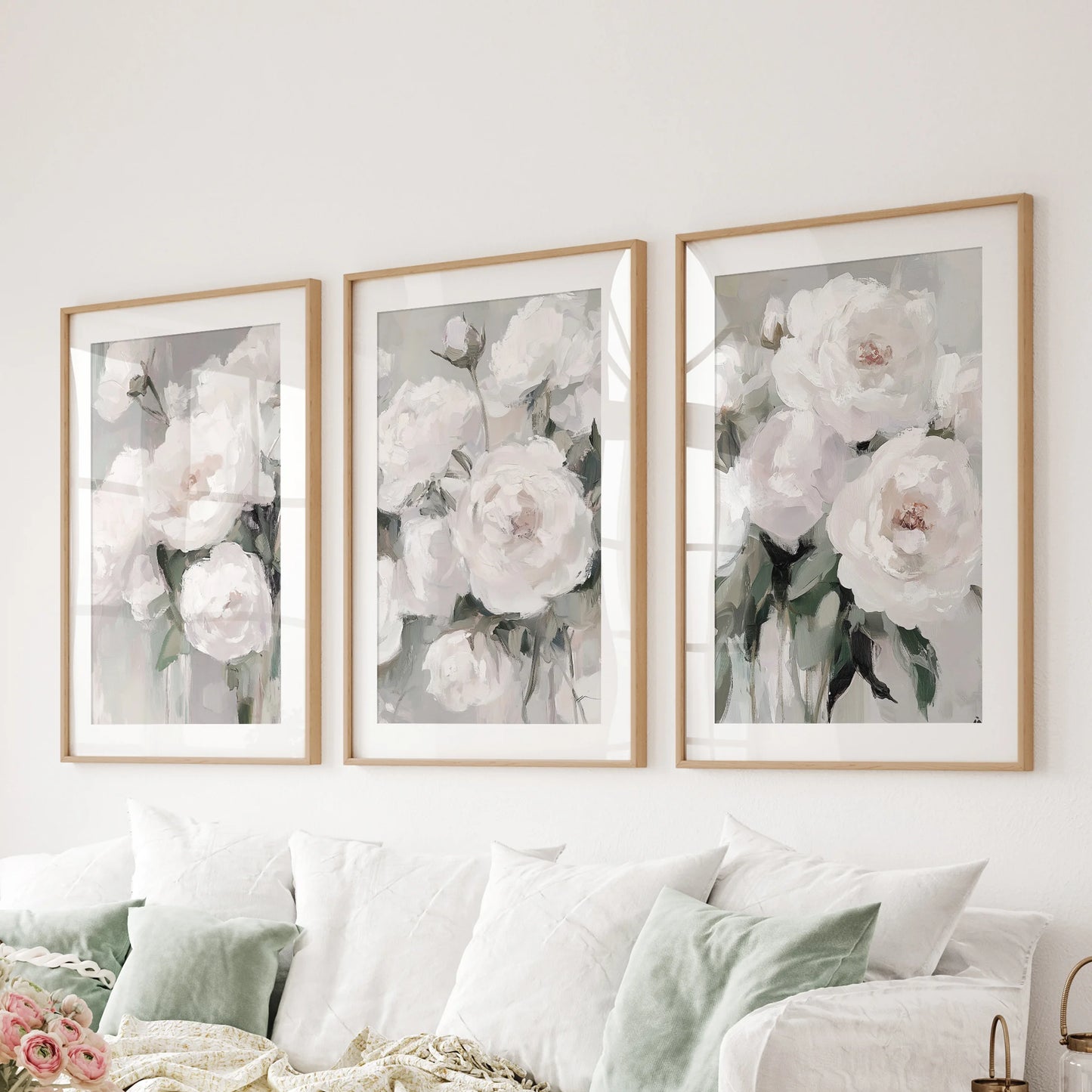 A 3-piece floral wall art suite in wood frames anchors the sitting area above the sectional with painterly, oil-style depth.