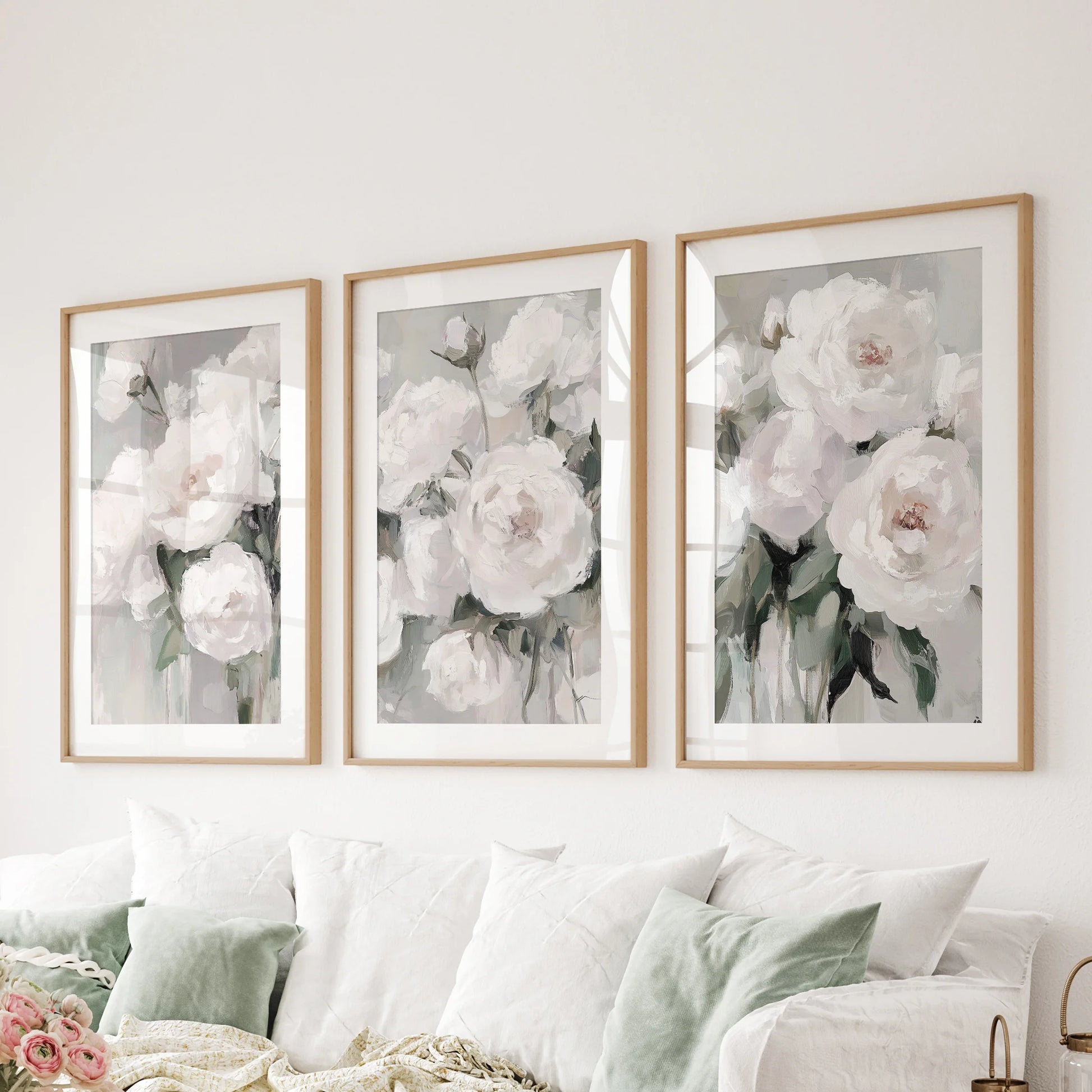 A 3-piece floral wall art suite in wood frames anchors the sitting area above the sectional with painterly, oil-style depth.