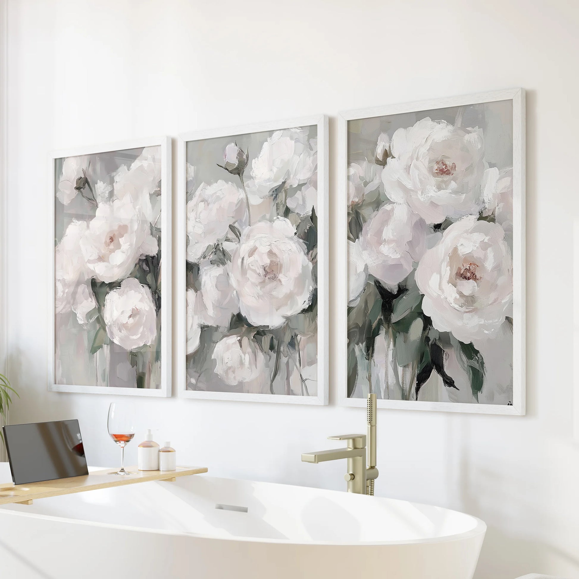 Three white-framed floral prints bring an oil-painted serenity above the bathtub, turning the bathroom into a spa-like retreat.