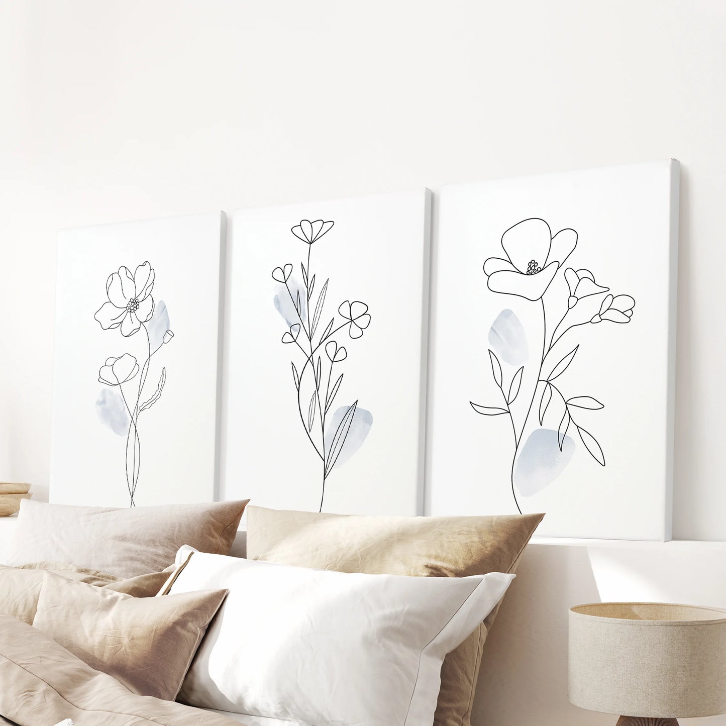 Pastel blue watercolor flowers, 3-print gallery wall on wrapped canvases, stretches over the bedroom headboard with tranquil, modern style.