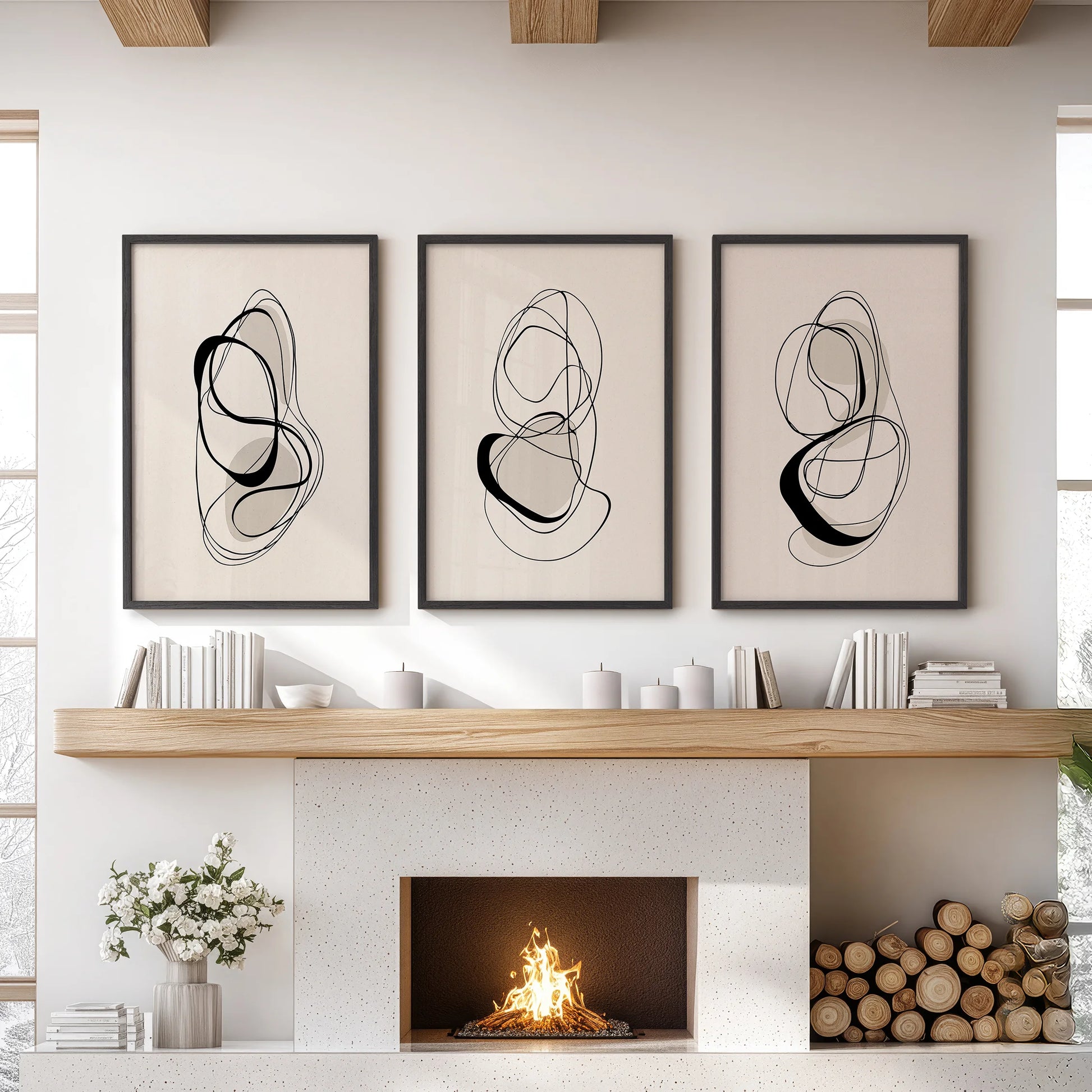 A three-piece wall decor set of minimalist one-line drawings in black frames, bringing clean black and beige contrast above a lounge mantel.