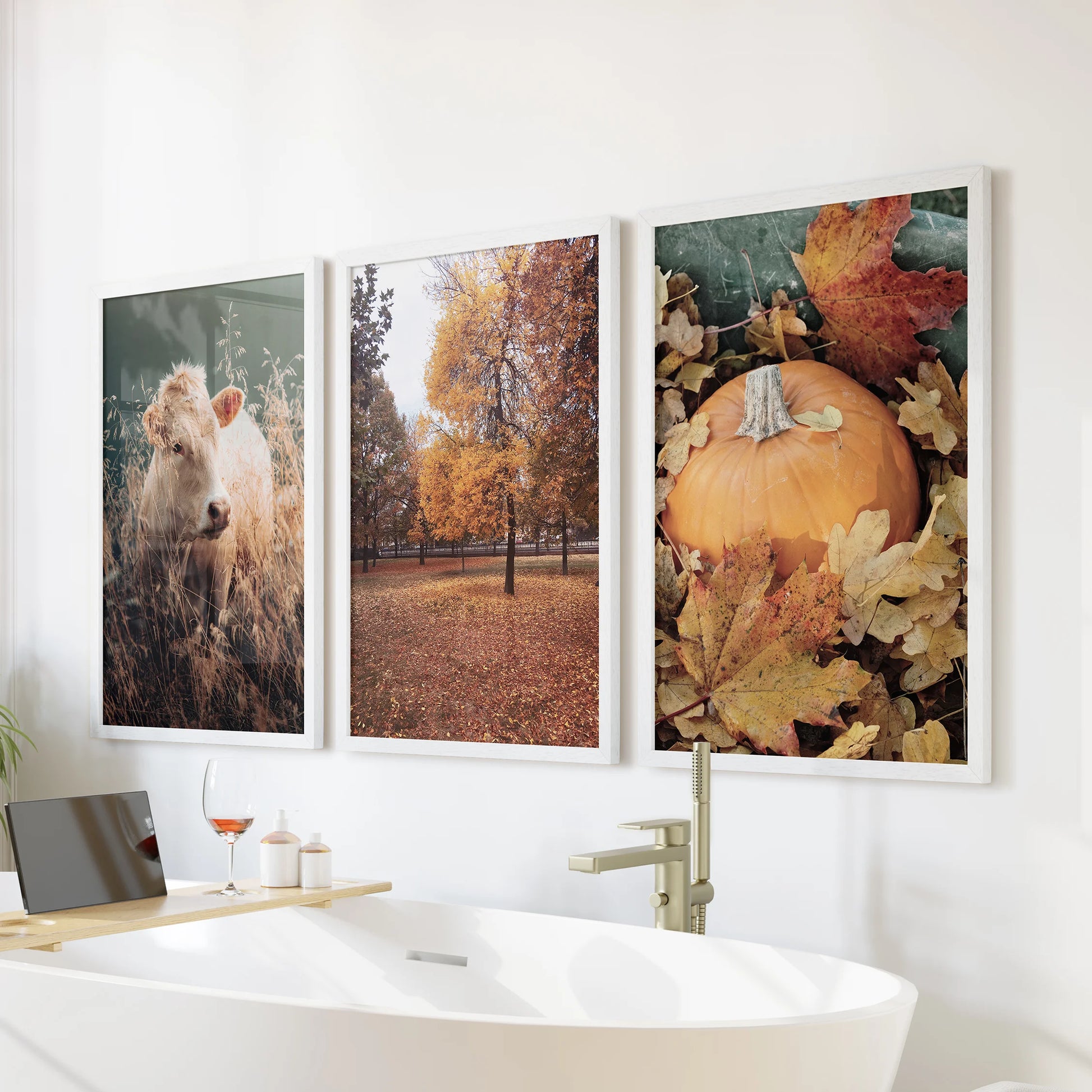 Pumpkin harvest prints, an art set of three in clean white frames, adds a warm seasonal note above the bathtub and softens the bathroom wall.