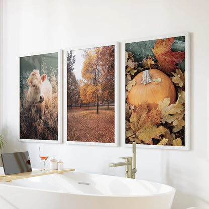 Pumpkin harvest prints, an art set of three in clean white frames, adds a warm seasonal note above the bathtub and softens the bathroom wall.