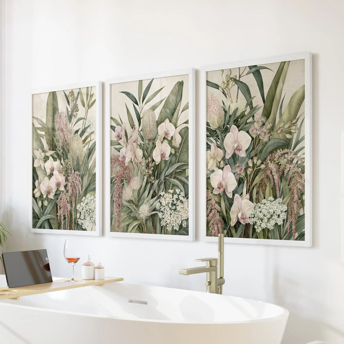 Pink orchid tropical wall art in three white frames above a freestanding bathtub.