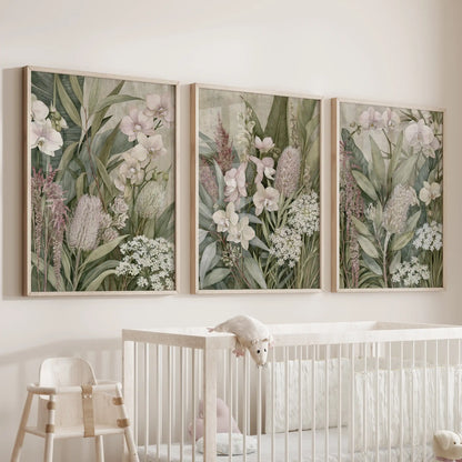 The three oak-framed prints above a crib show orchids, rounded flower heads and small white blooms layered among upright green leaves.