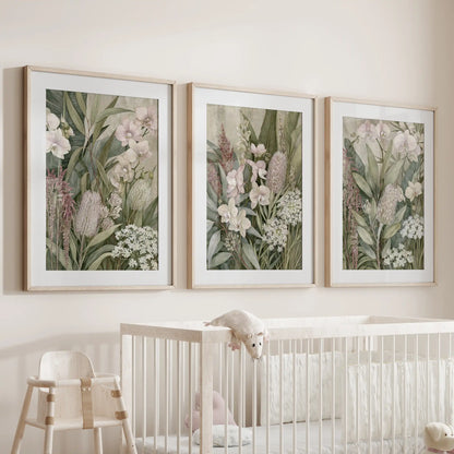 Matted oak frames surround three orchid and tropical flower prints above a crib.