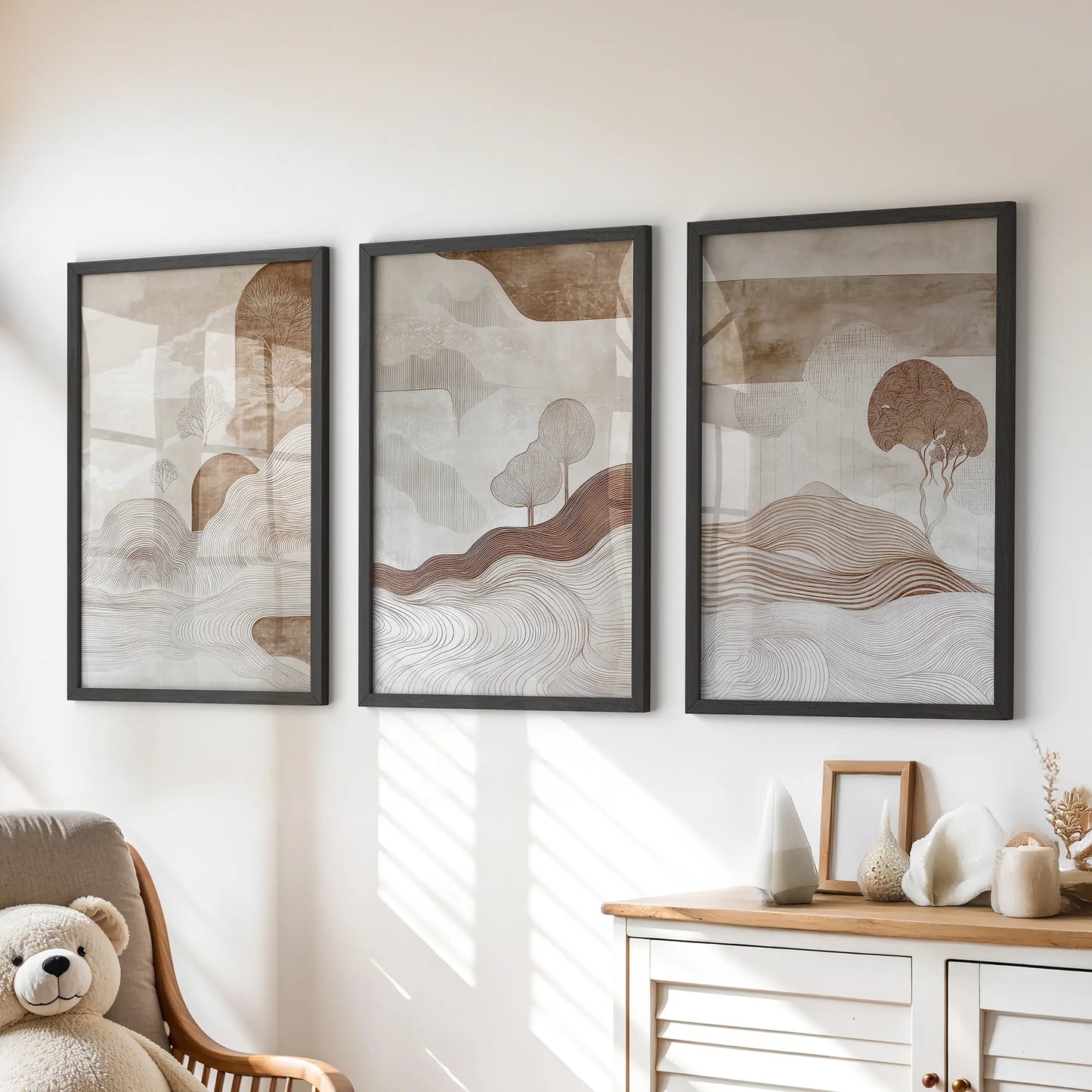 Organic forms in warm neutrals set of three posters, framed in black, bring soft texture and playful calm to a kids playroom over the chest of drawers.