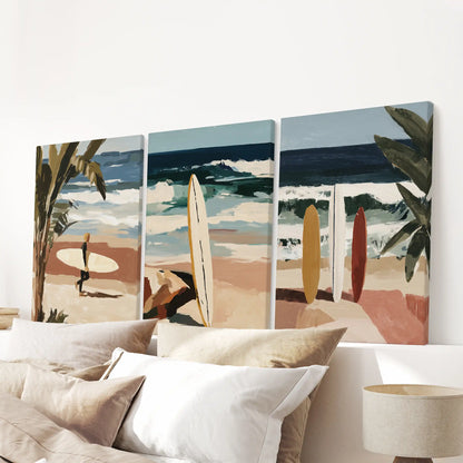 A gallery-wrapped trio of surfboard posters crowns the bedroom above the headboard, adding crisp shapes and balanced beach color.