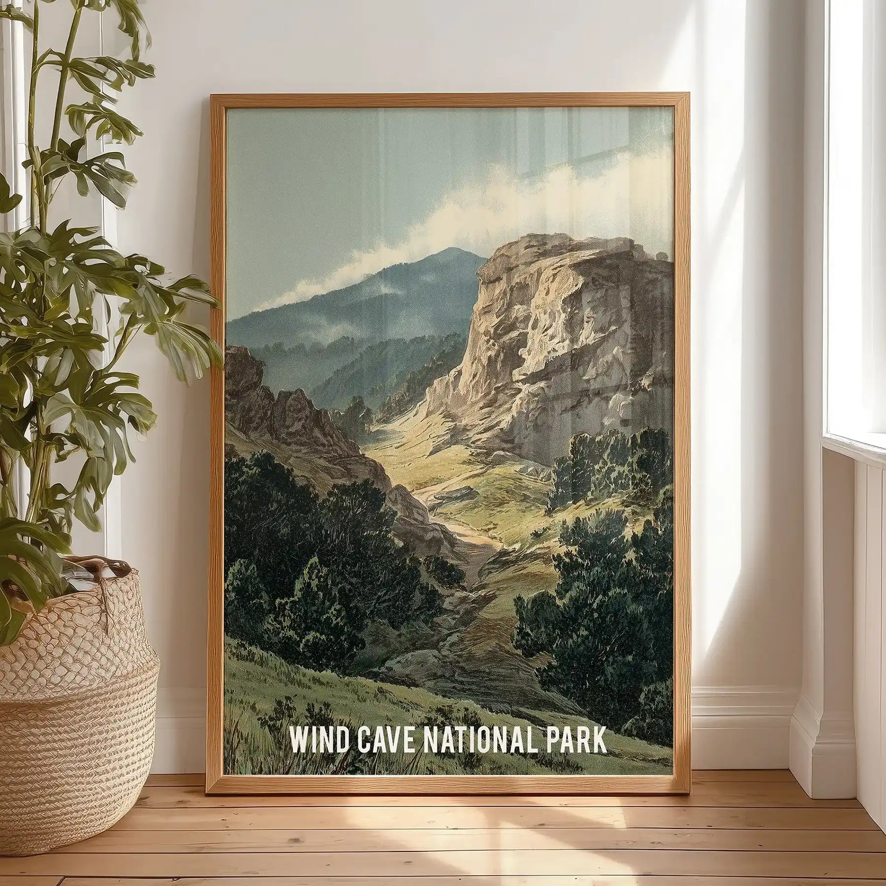 Rock and pine forest landscape wall decor in a light wood frame leans against the bedroom wall by the window, bringing grounded texture to a restful corner.