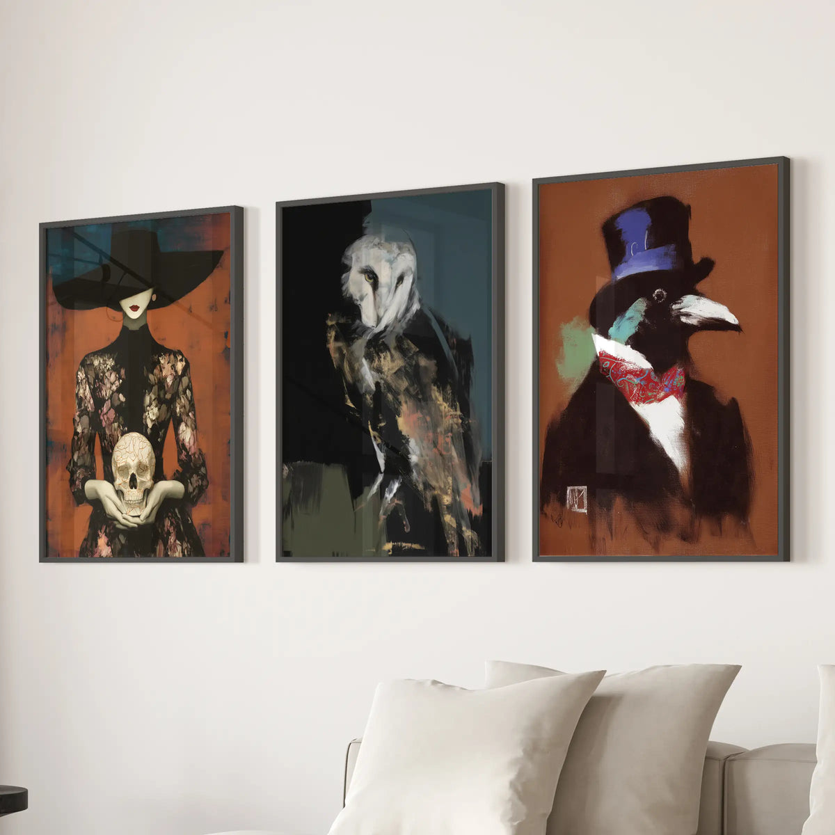 Set of three wall art prints featuring an owl, skull, and raven in black frames, hung over a living room sofa.