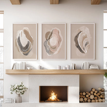 A set of three oyster shell prints in white frames gathers over the sitting-room mantel for a light, breezy coastal finish.