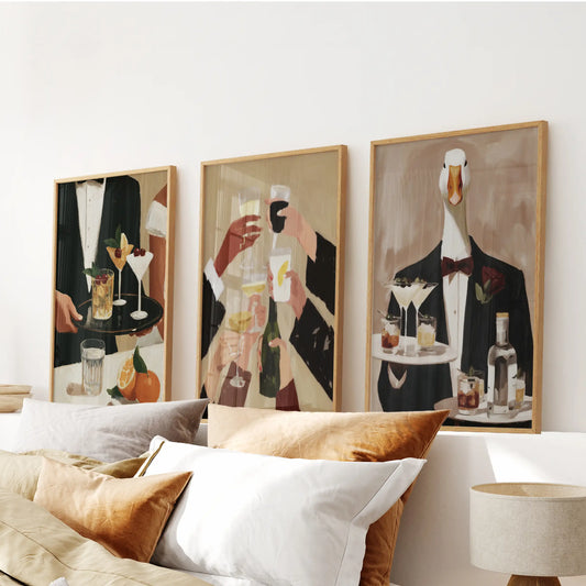 Painterly bartender wall art in a set of three prints, displayed in solid oak frames above a bedroom headboard.