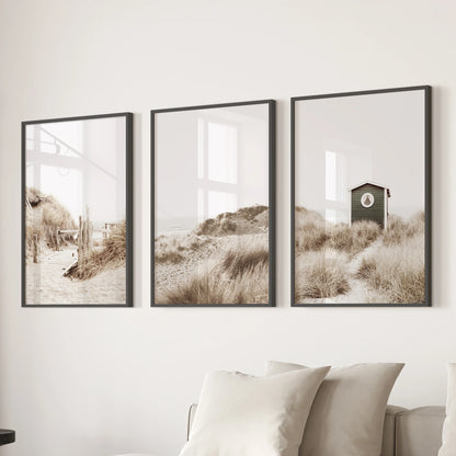 Summer seascape three-piece wall art in black frames drifts over the lounge sectional, its pastel horizon lending an easy, beachy hush to the space.