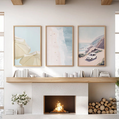 Three light-wood-framed ocean prints wash the sitting-room wall above the mantle in tide-softened color.