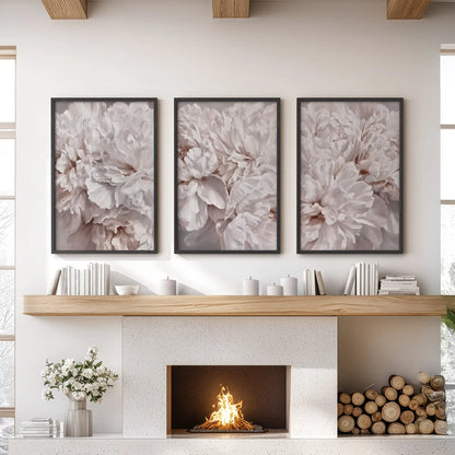 Layers of ruffled peony petals in blush, ivory and taupe fill three black-framed prints above a fireplace, with no stems visible.