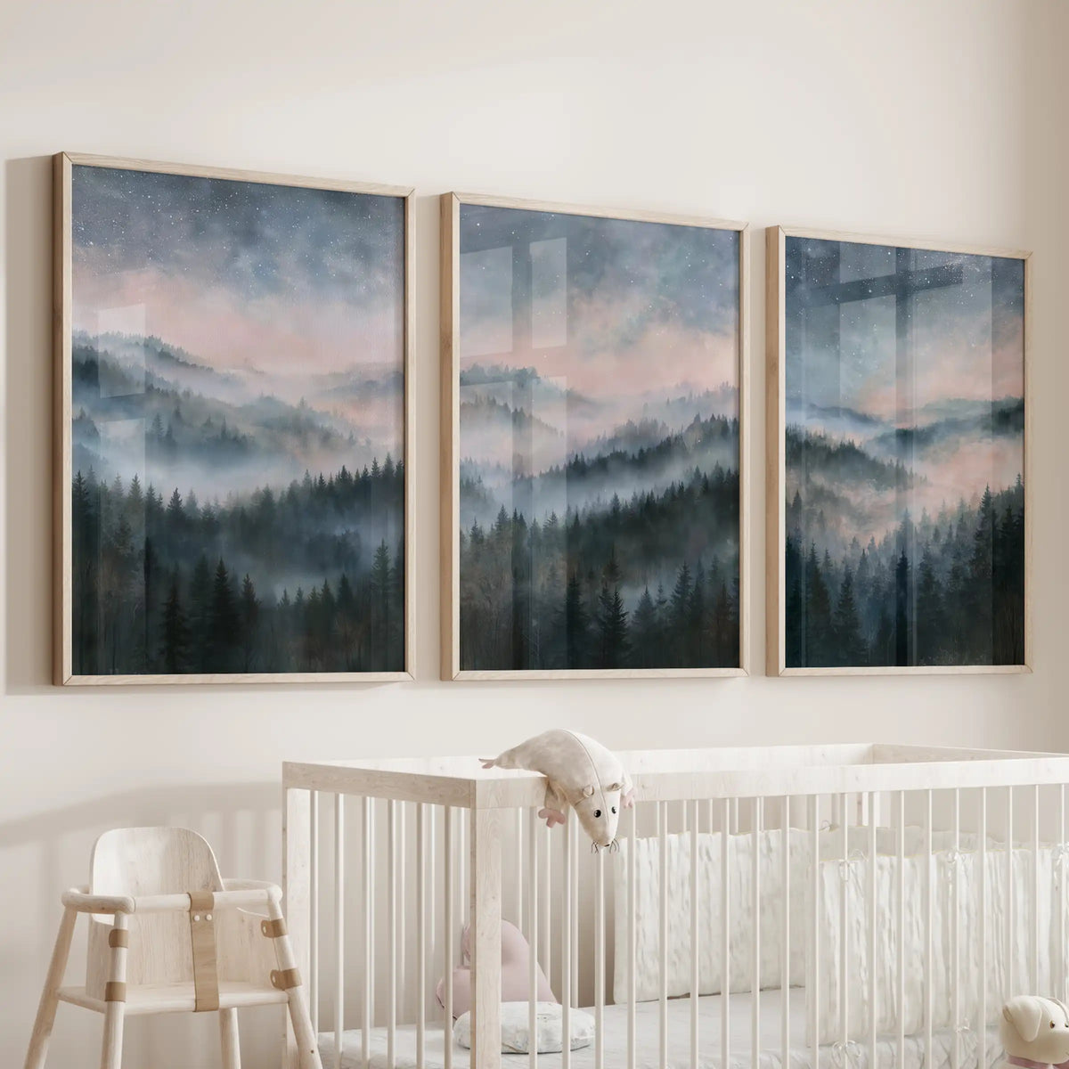 Blue watercolor landscape wall art comes as a three-piece set in solid oak frames, softly hung above the cot in the nursery.