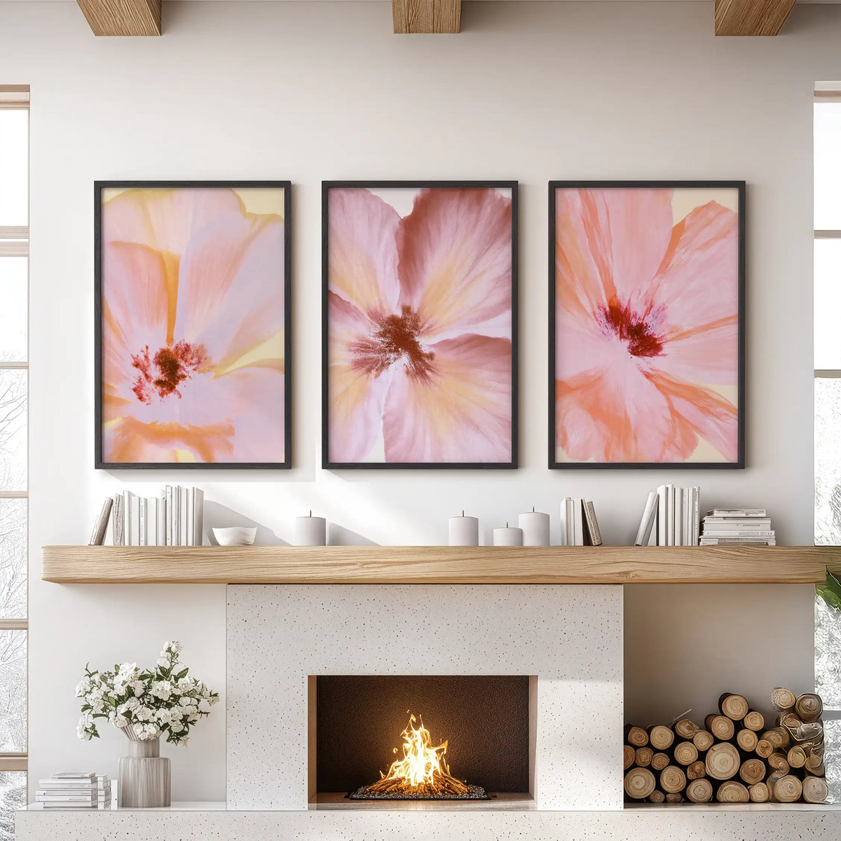 Three pink and peach flower prints in black frames above a fireplace.