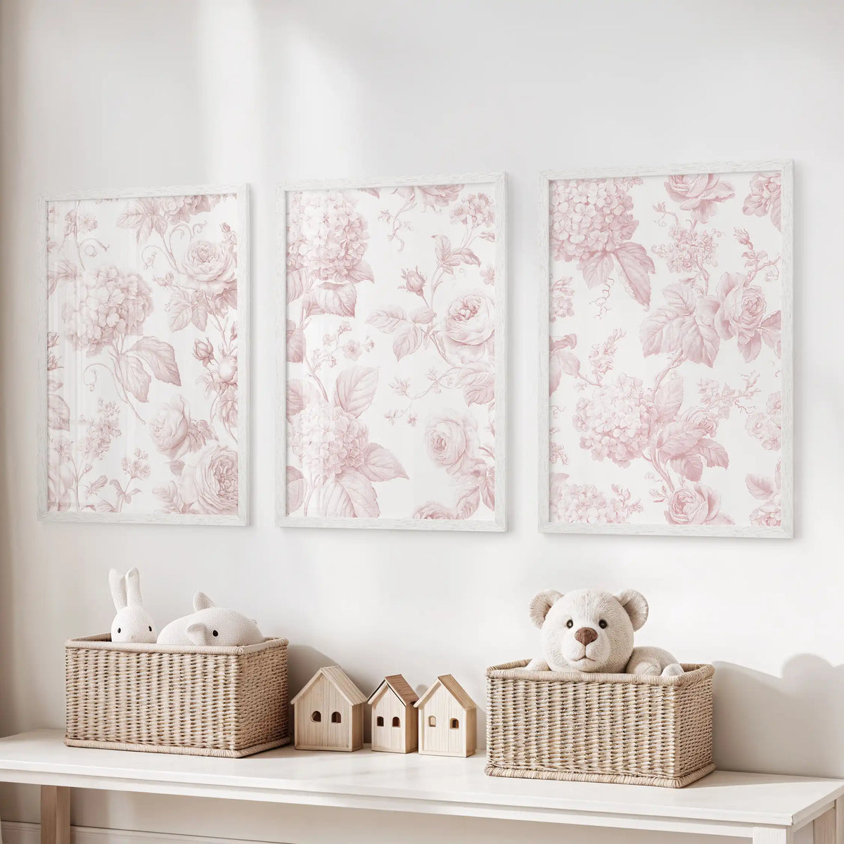 The three prints above toy baskets show pink roses and rounded flower clusters on cream grounds, enclosed in slim white frames.