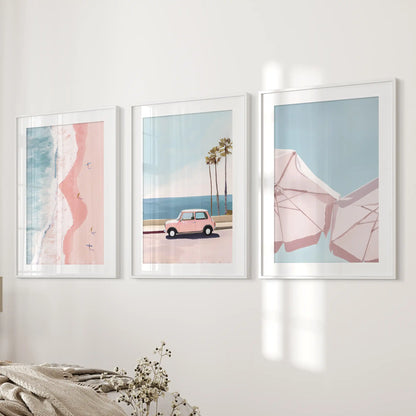 Vintage beach car, a set of three wall art prints in white frames with matting, lends rosy coastal nostalgia beside the bed wall in the bedroom.