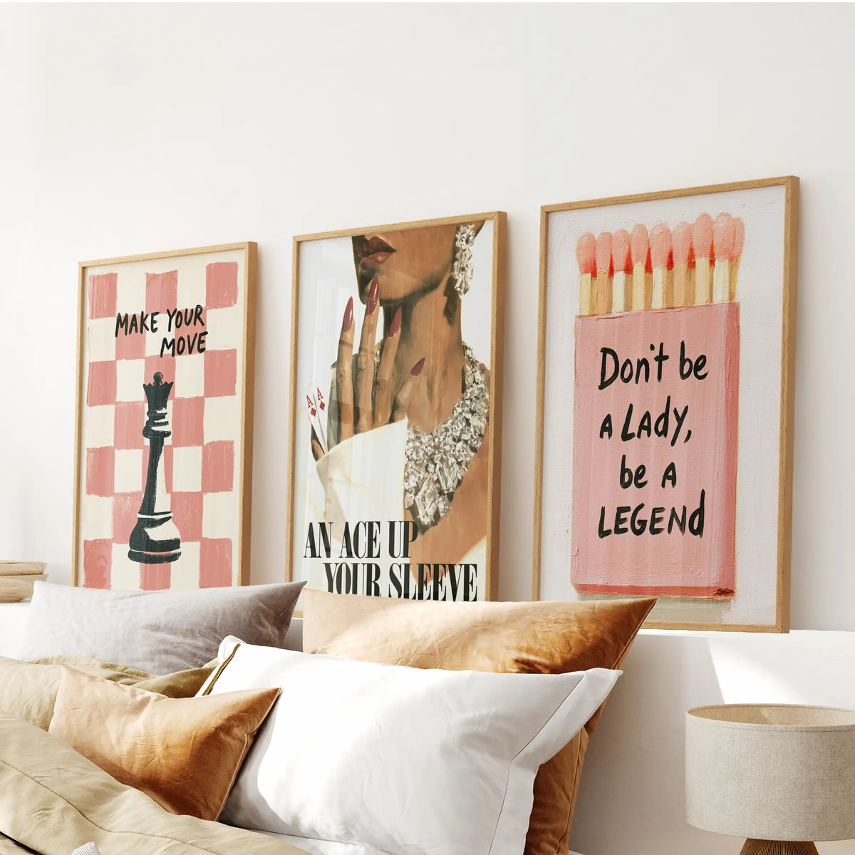Fashion portrait three-piece art print set in thin wood frames, hung over the bed headboard in a bedroom.