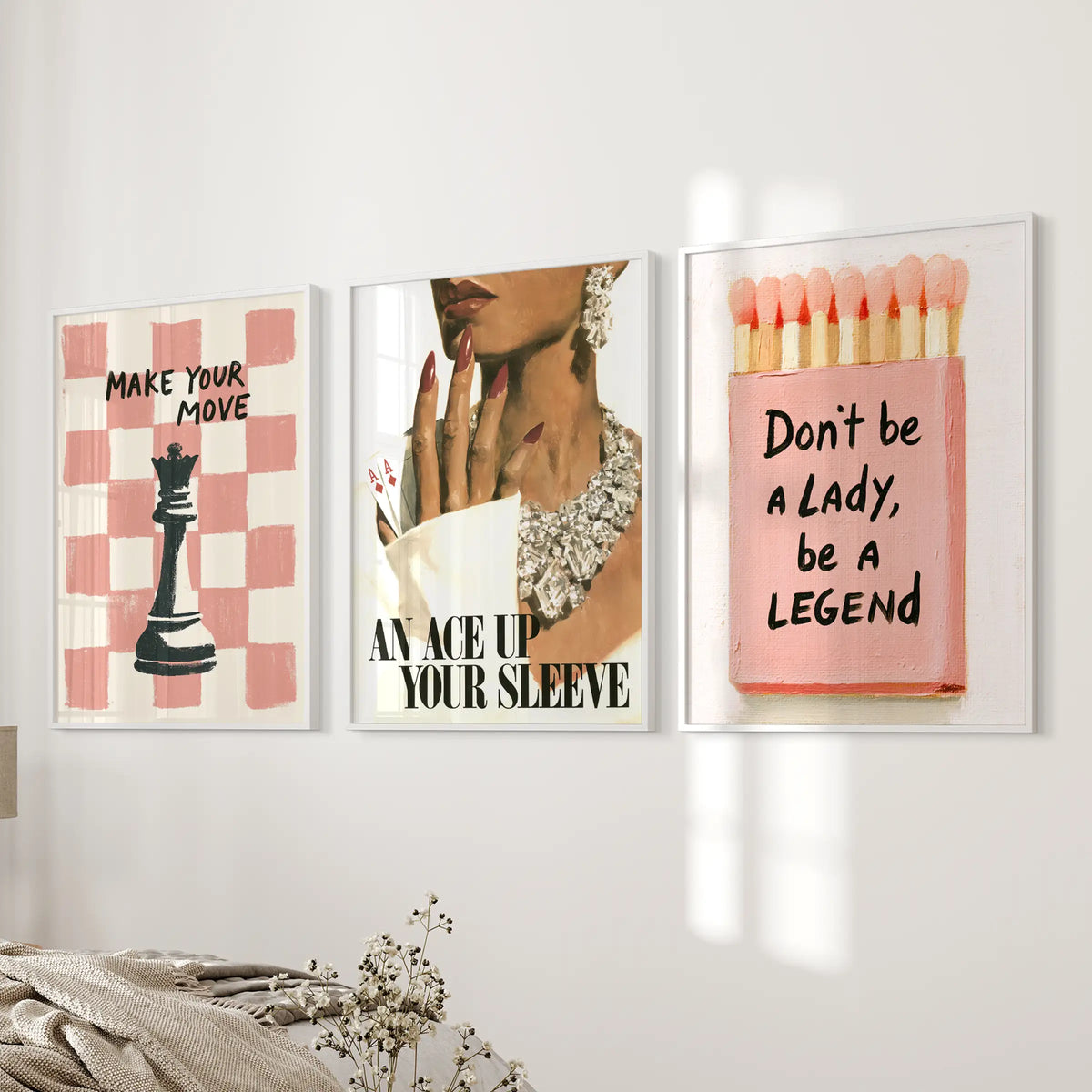 Fashion portrait three-piece wall art set in white frames, displayed together on a bedroom wall.