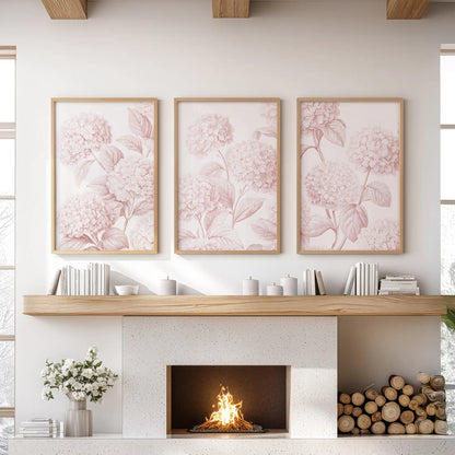 Above a fireplace, oak frames surround three prints of pale pink hydrangeas branching across white backgrounds.
