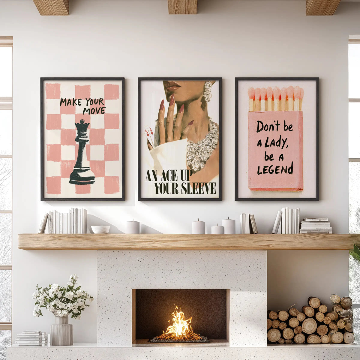 Pink glamour poster trio set in black frames, displayed over the fireplace mantel in a family room.