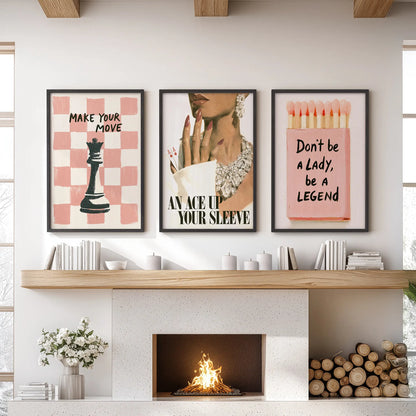 Pink glamour poster trio set in black frames, displayed over the fireplace mantel in a family room.