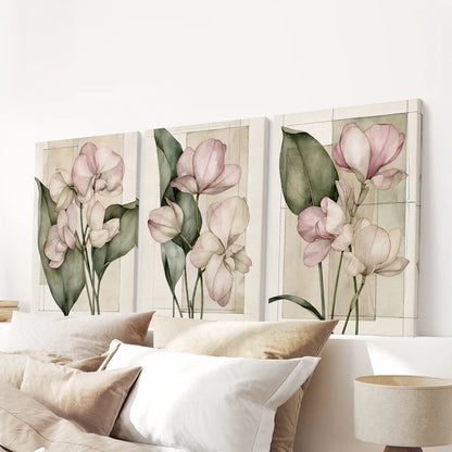 Pale pink blossoms and green leaves fill three canvases above a bed.