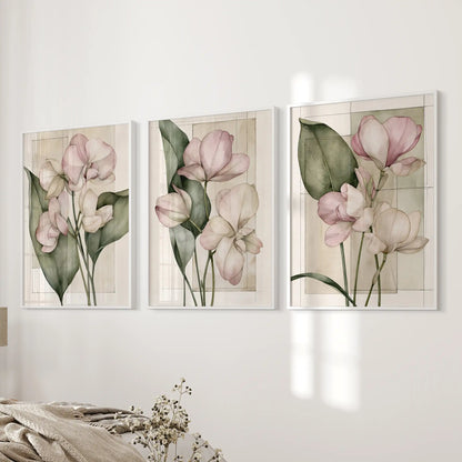 Fine outlines define the pink petals in three white-framed prints beside a bed, with long green leaves and faint rectangles on cream grounds.